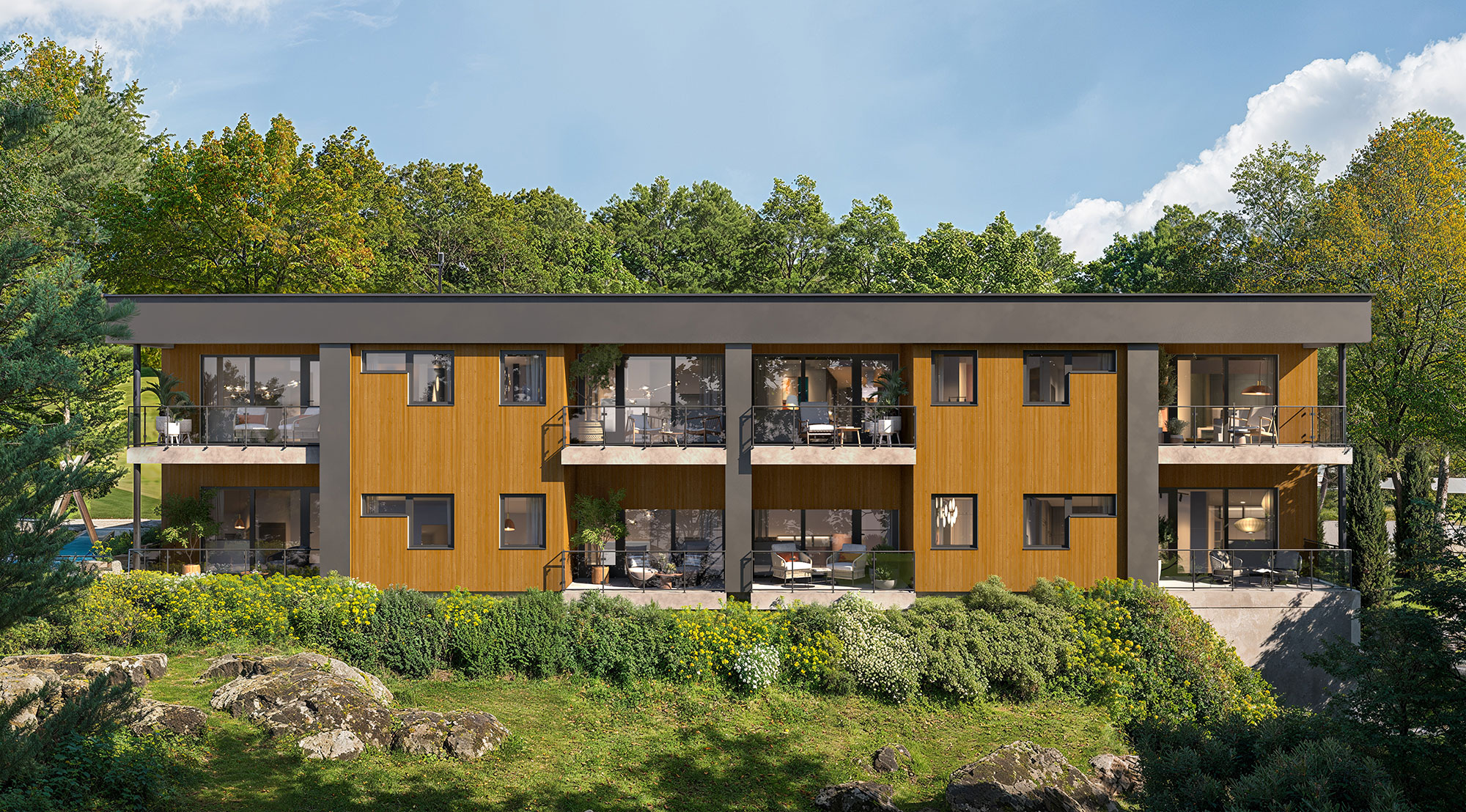 Bygg 1 sett fra sør med eikeskog og bergknauser i forgrunnen